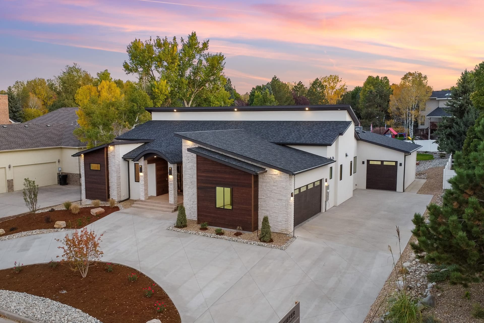 Aerial angled view showing roof geometry and neighborhood setting