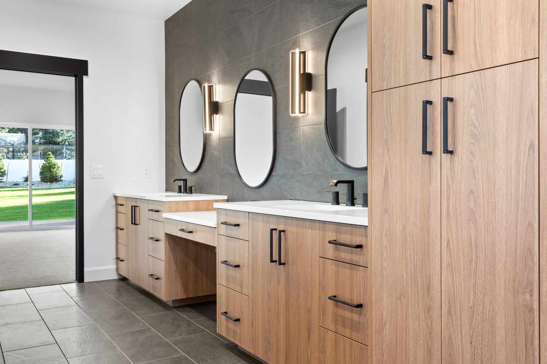 Bathroom vanity detail with warm cabinetry by Kiefer Built Contracting